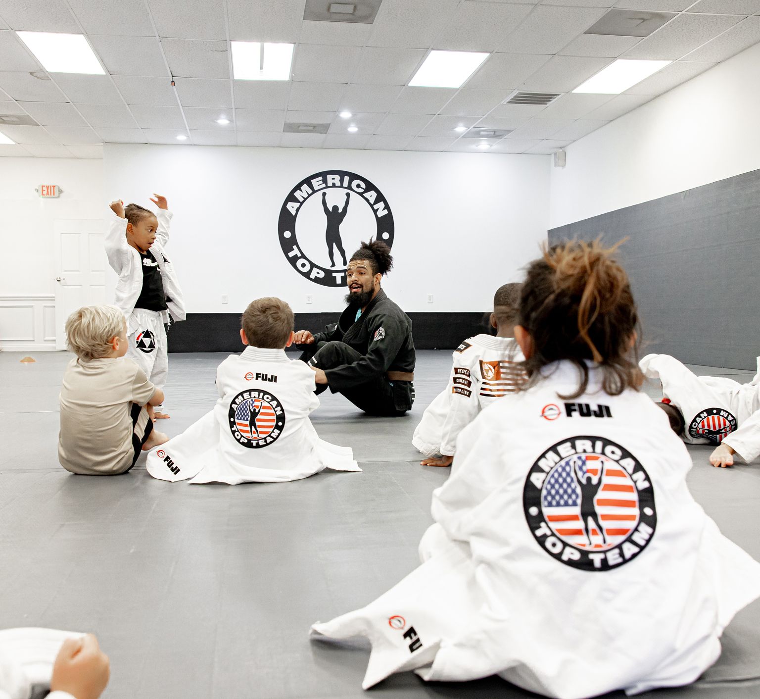 Coaches working with young students at Miller Martial Arts